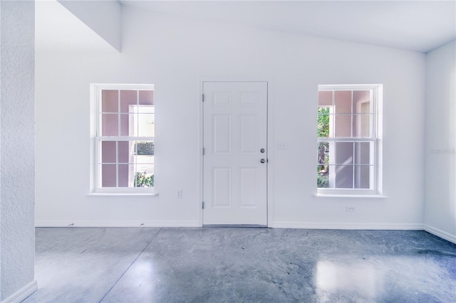 empty room featuring plenty of natural light and concrete floors