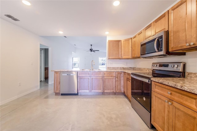 kitchen with sink, light stone counters, appliances with stainless steel finishes, kitchen peninsula, and ceiling fan