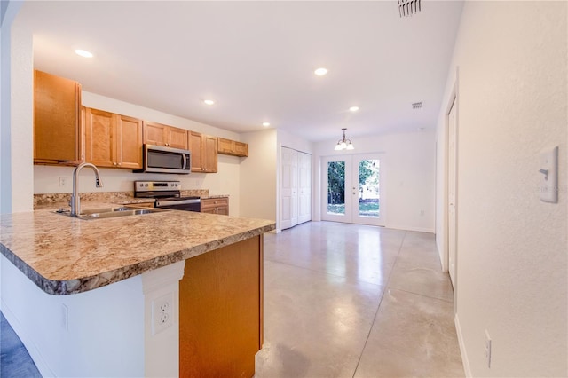 kitchen featuring french doors, a breakfast bar, sink, kitchen peninsula, and stainless steel appliances