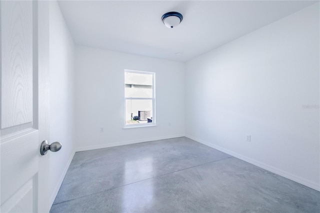 unfurnished room with concrete floors