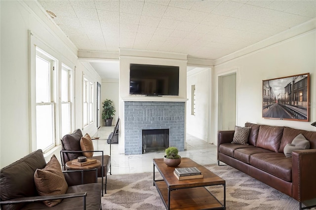 living room with crown molding and a brick fireplace