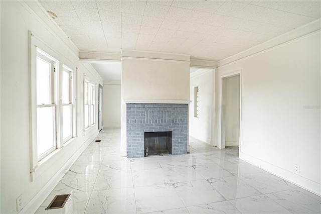 unfurnished living room with crown molding and a brick fireplace