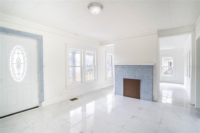 unfurnished living room featuring a fireplace and ornamental molding