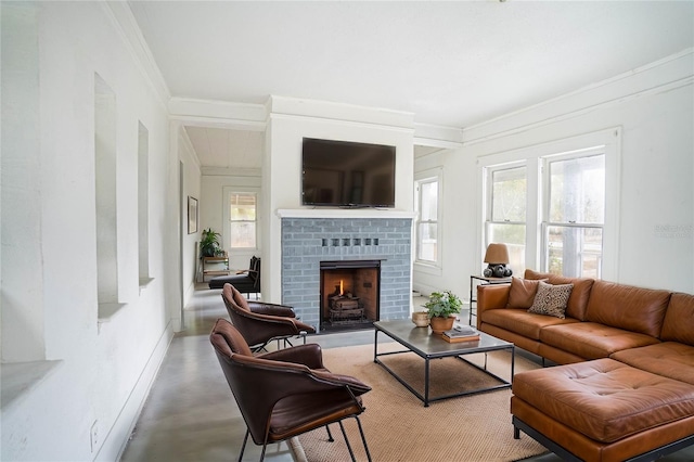 living room featuring crown molding, a healthy amount of sunlight, a brick fireplace, and concrete floors