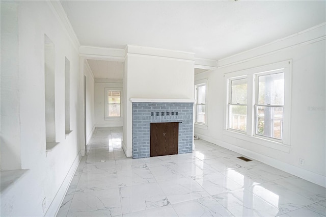 unfurnished living room featuring ornamental molding and a brick fireplace