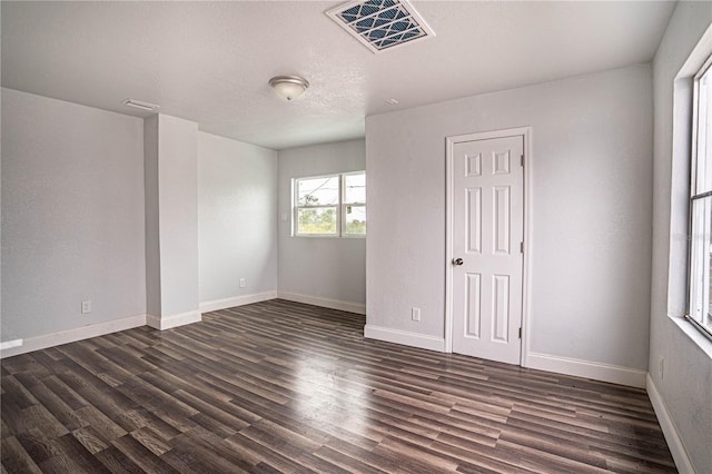 unfurnished room featuring dark wood-type flooring