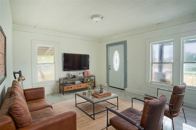 living room with ornamental molding and light tile patterned floors