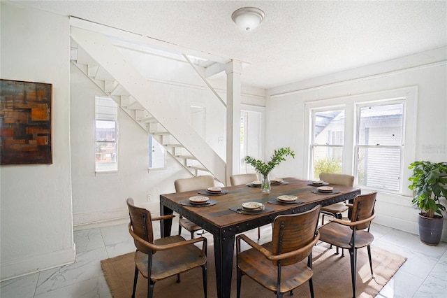 dining room featuring a textured ceiling