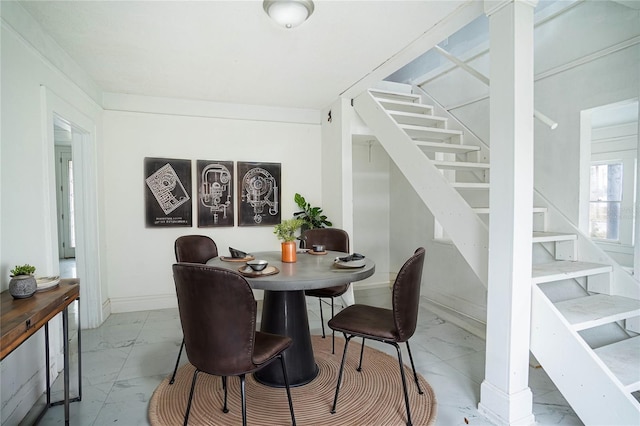 dining area featuring decorative columns