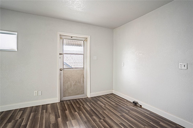 spare room with dark wood-type flooring