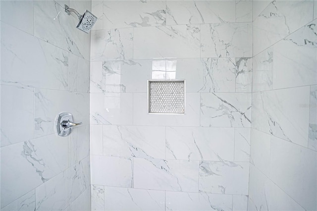 bathroom with a tile shower