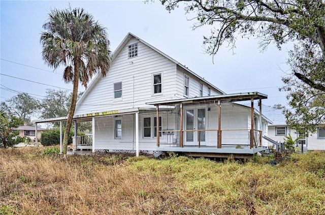 rear view of house featuring a porch