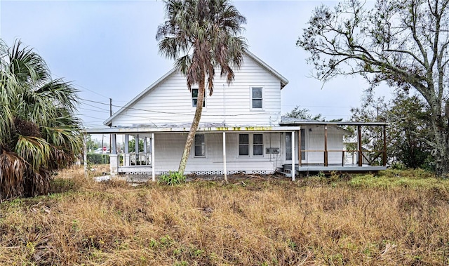 back of property with covered porch