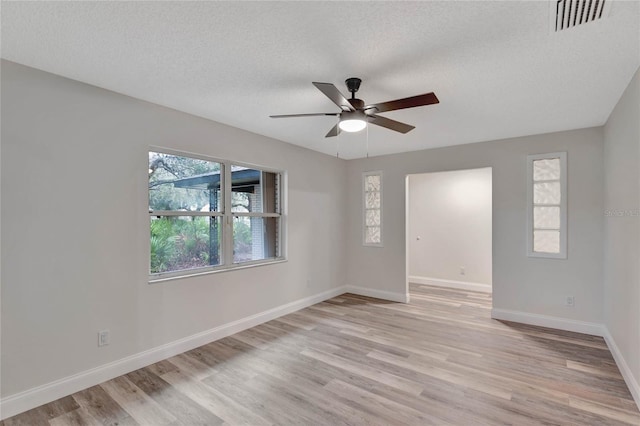 unfurnished room with ceiling fan, light hardwood / wood-style floors, and a textured ceiling