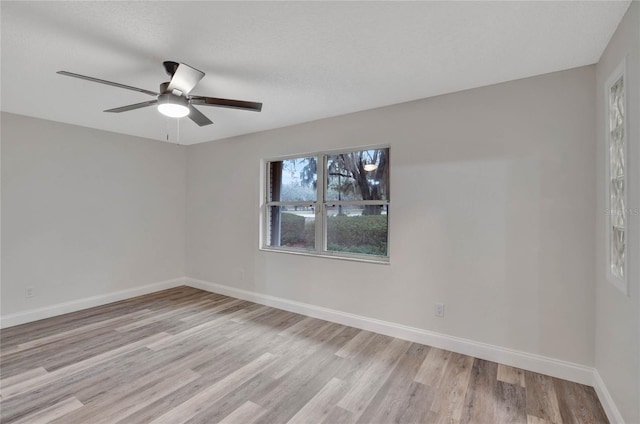 empty room featuring ceiling fan and light wood-type flooring