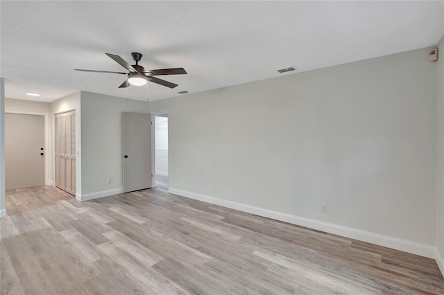 empty room featuring ceiling fan and light hardwood / wood-style floors