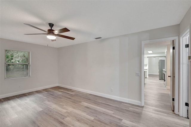 spare room with ceiling fan and light hardwood / wood-style flooring