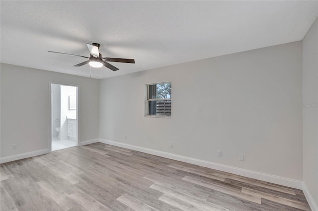 empty room with ceiling fan, light hardwood / wood-style flooring, and a textured ceiling