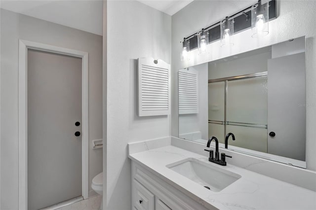 bathroom featuring tile patterned flooring, vanity, walk in shower, and toilet