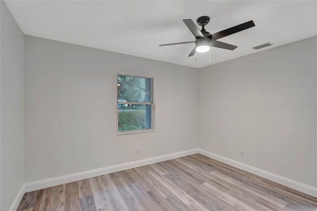 spare room featuring ceiling fan, a textured ceiling, and light hardwood / wood-style floors