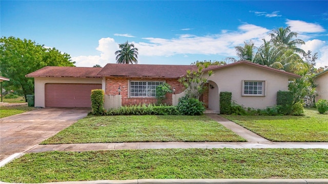 single story home with a garage and a front lawn