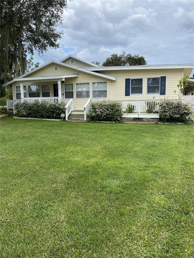 view of front facade with a front yard and a porch