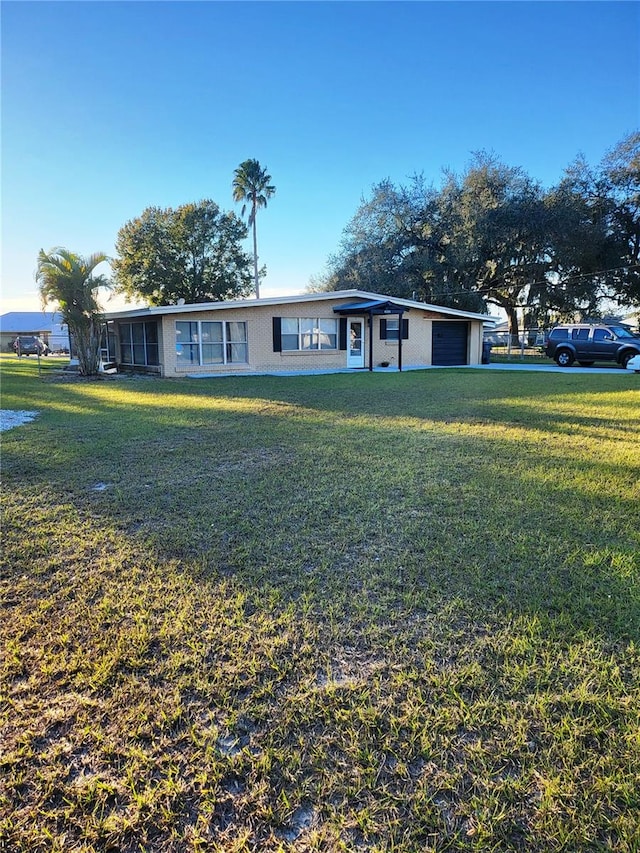 single story home with a garage and a front yard