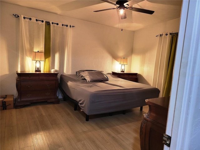 bedroom with ceiling fan and light hardwood / wood-style floors