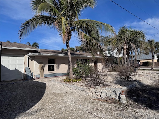 rear view of house with a garage