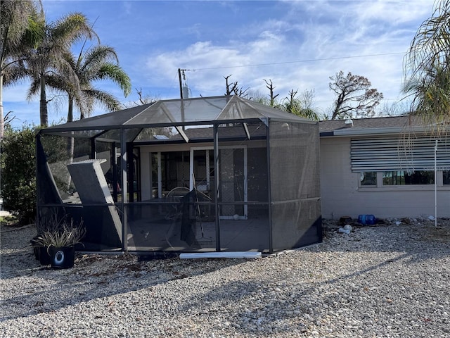 back of property featuring a lanai