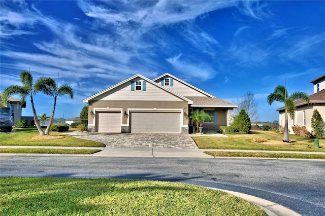 view of front of property with a garage and a front lawn