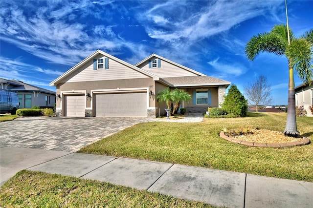 view of front of house with a garage and a front lawn