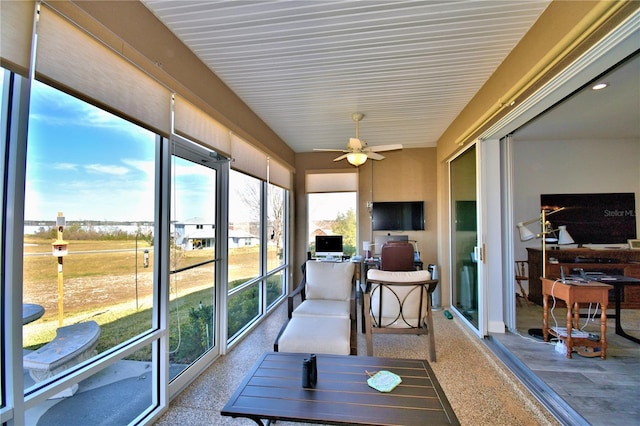 sunroom featuring ceiling fan