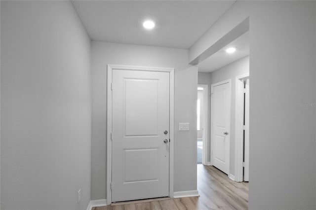 corridor with light wood-type flooring