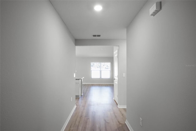 corridor with light hardwood / wood-style flooring