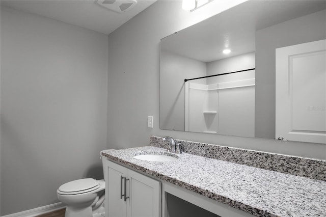 bathroom with vanity, hardwood / wood-style flooring, toilet, and a shower