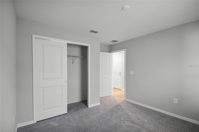 unfurnished bedroom featuring carpet flooring and a closet