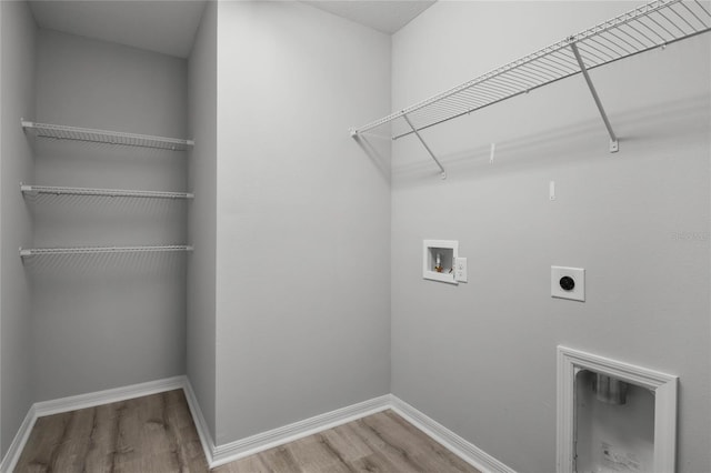 clothes washing area with hookup for an electric dryer, hookup for a washing machine, and hardwood / wood-style floors