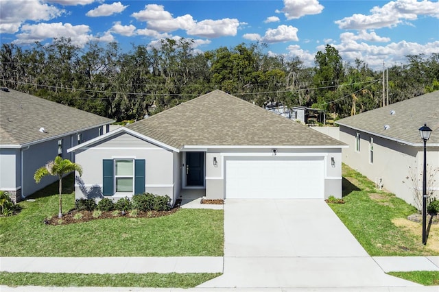 ranch-style home with a garage and a front lawn