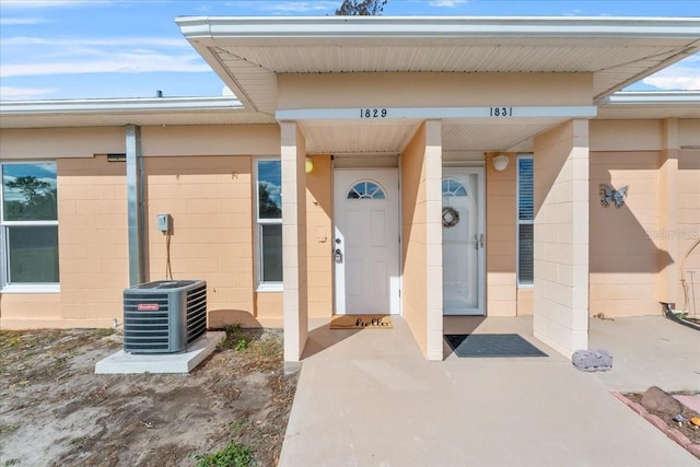 property entrance featuring central AC unit