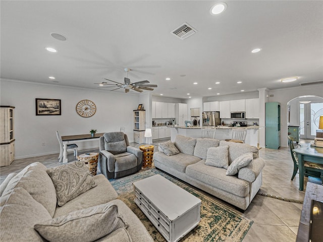 living room with crown molding and ceiling fan