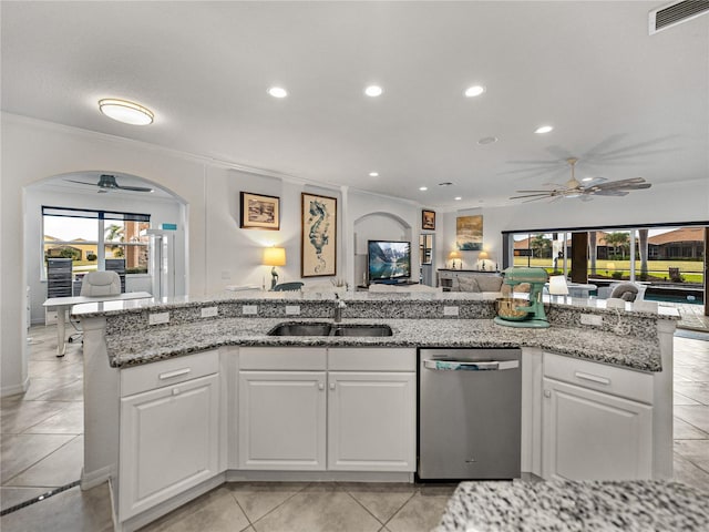 kitchen featuring white cabinetry, sink, stainless steel dishwasher, crown molding, and plenty of natural light