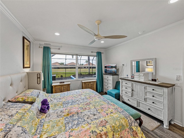 bedroom featuring hardwood / wood-style flooring, ceiling fan, and crown molding