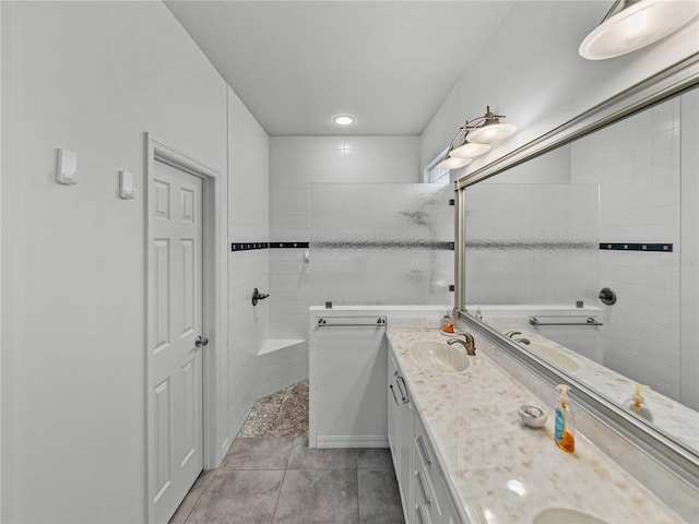 bathroom with tile patterned floors, vanity, and tiled shower