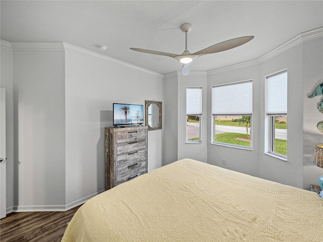 bedroom with ornamental molding, dark hardwood / wood-style floors, and ceiling fan