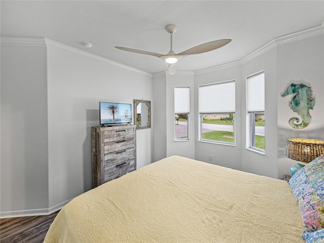 bedroom with dark hardwood / wood-style flooring, crown molding, and ceiling fan