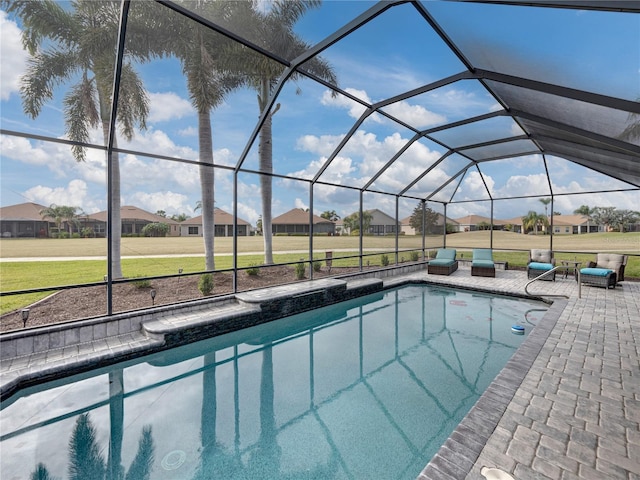 view of swimming pool with a patio, a lanai, and a yard