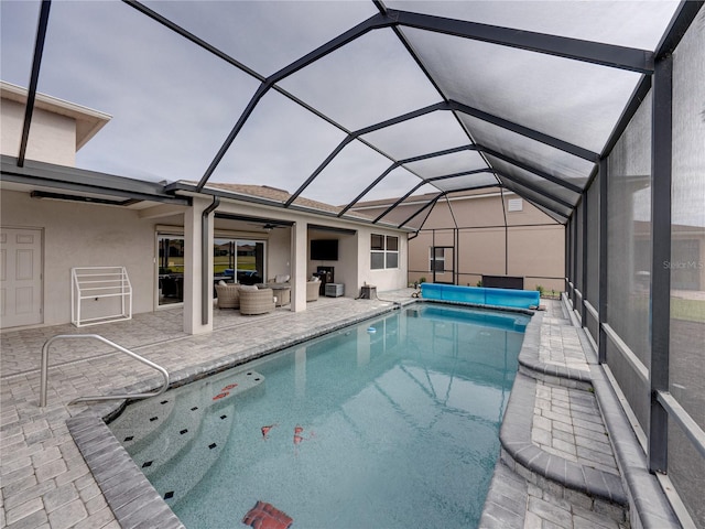 view of swimming pool featuring a lanai, an outdoor hangout area, and a patio