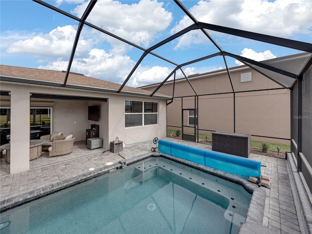 view of pool with an outdoor living space, a patio, and a lanai