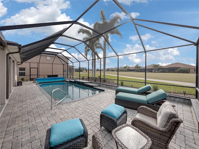 view of pool with an outdoor living space, a lanai, and a patio area